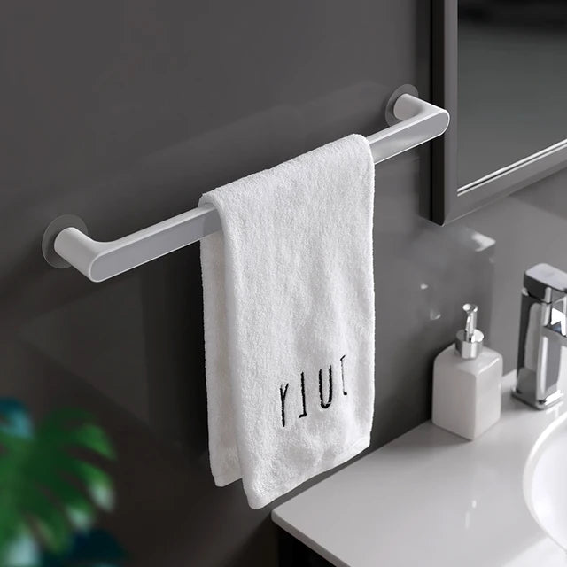 A towel is organized on the Towel Organizer Hanger in gray color