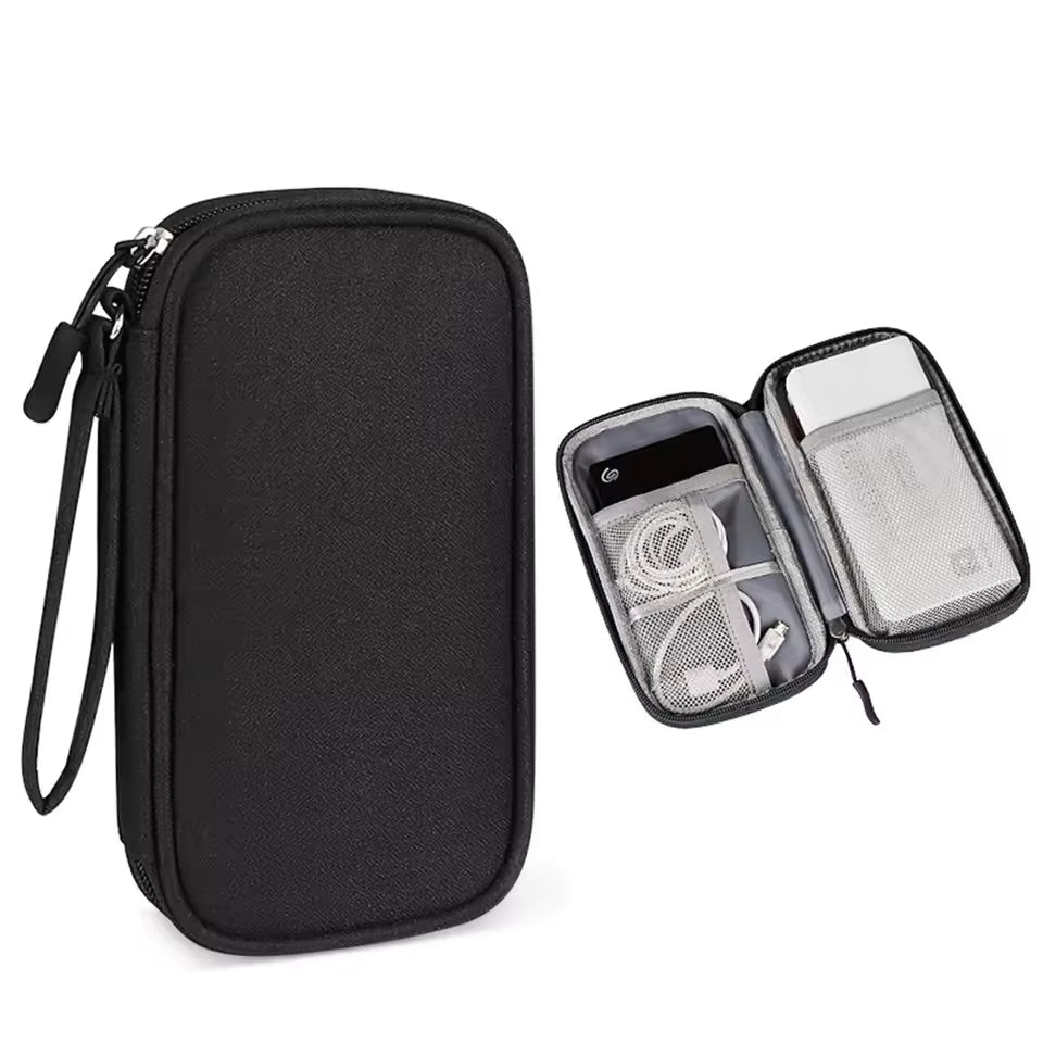 Black travel case with a clear compartment containing electronic devices on a white background
