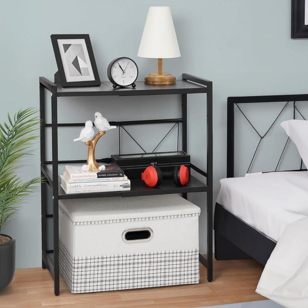 Expandable Microwave Oven Rack Shelf is Kept Near Bed and Organized with Decor Items.