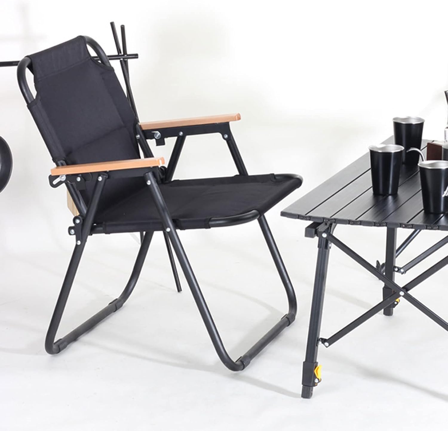 A Folding Camping Chair is Placed near a Table.