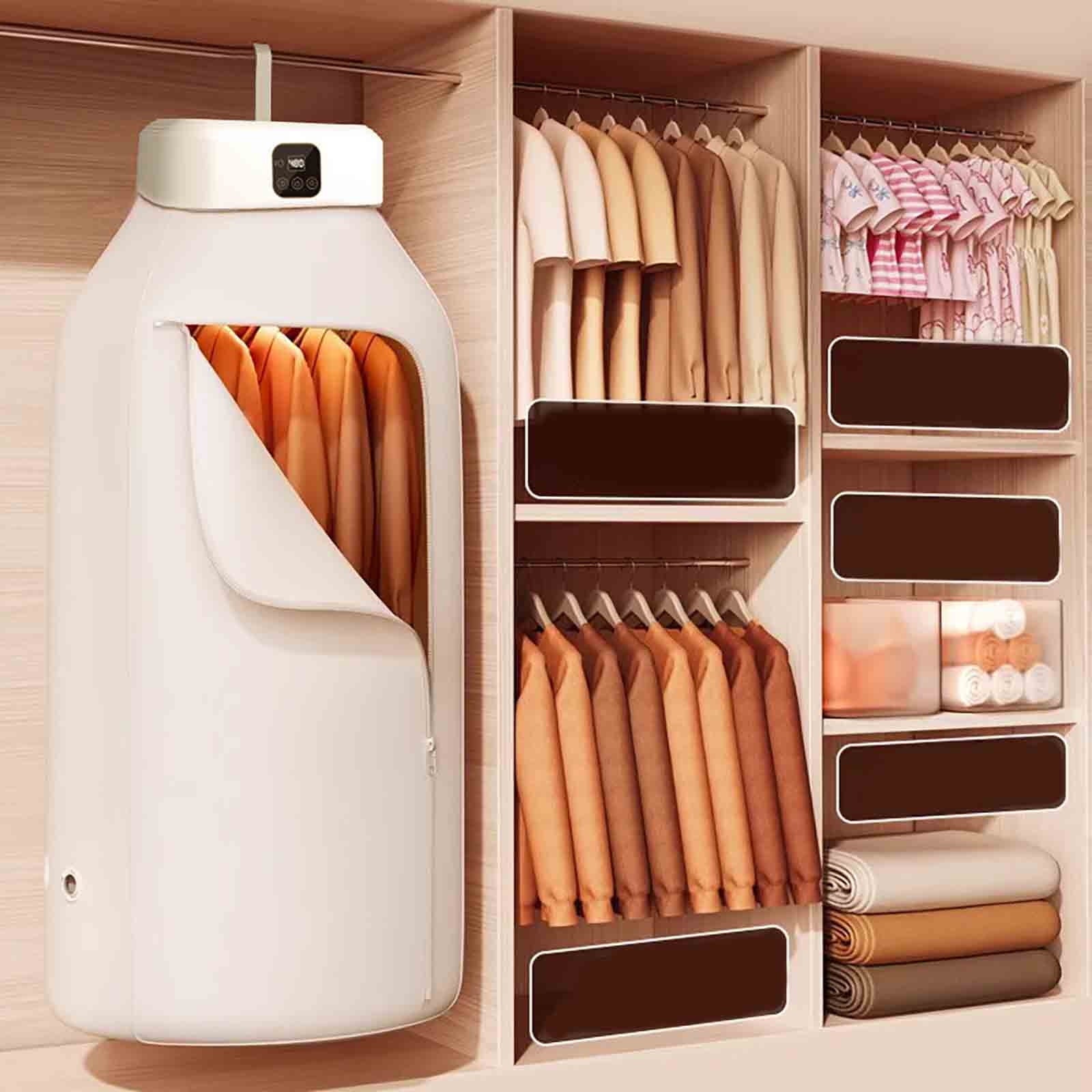 Folding Electric Cloth Dryer With Cloths Hanged On the Wardrobe.