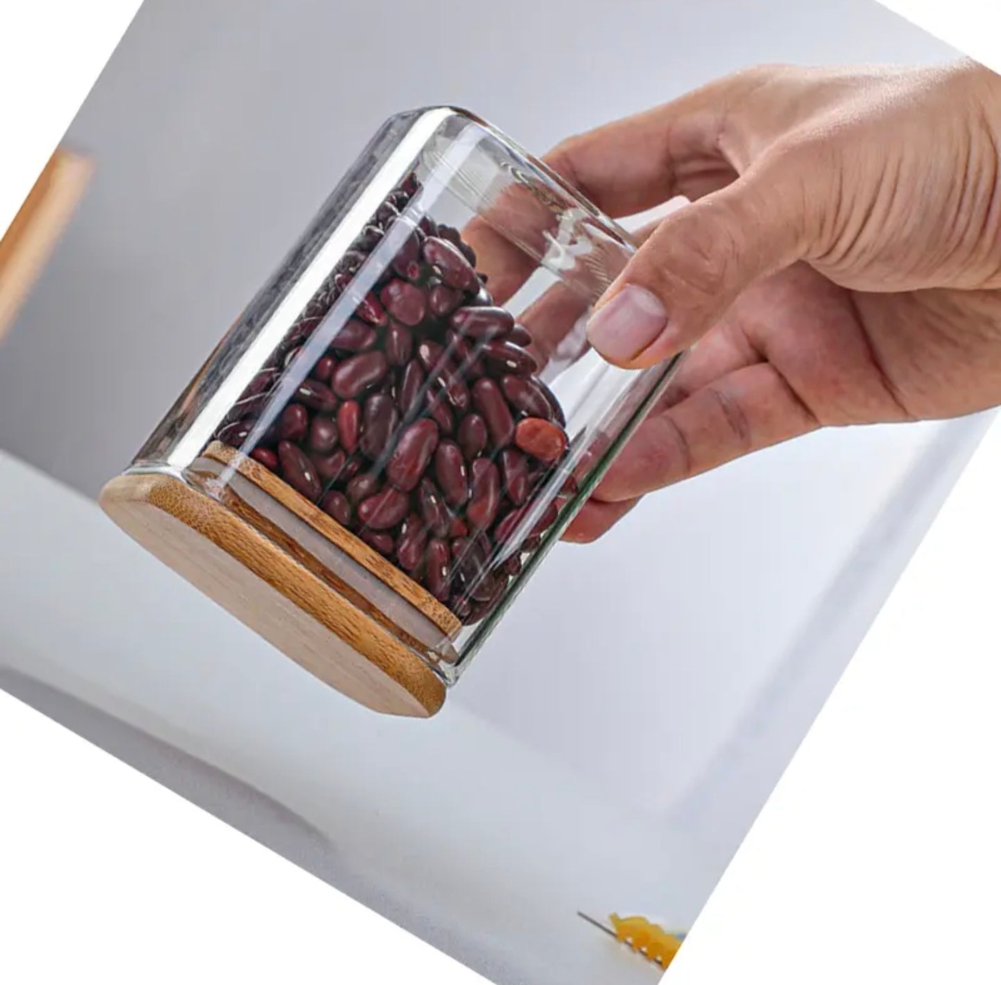 A Person is Holding Storage Jar in a Upside Down Position.