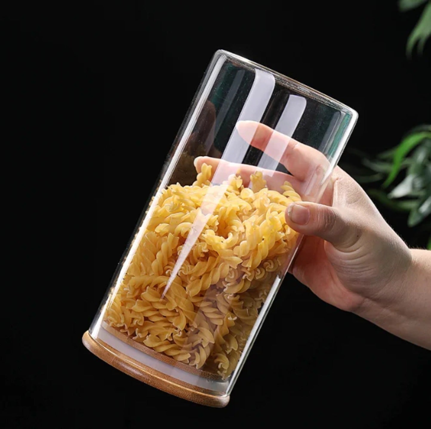 A Person is Holding Glass Storage Jars Upside Down.