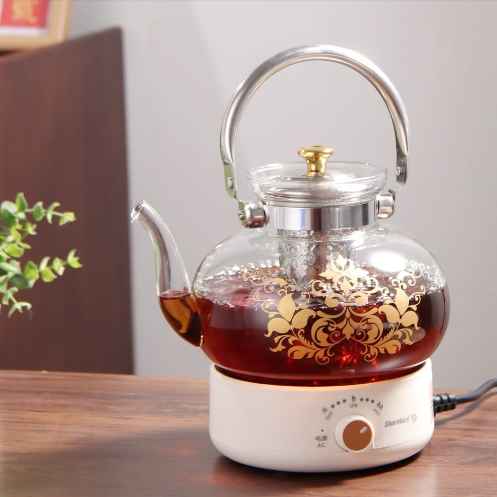 A Glass Tea & Coffee Pot Placed on a Heat Flame.