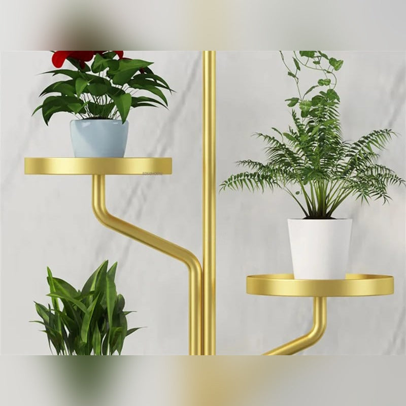 Parts Of Golden color Indoor Plant Stands placed in a room along with plants.