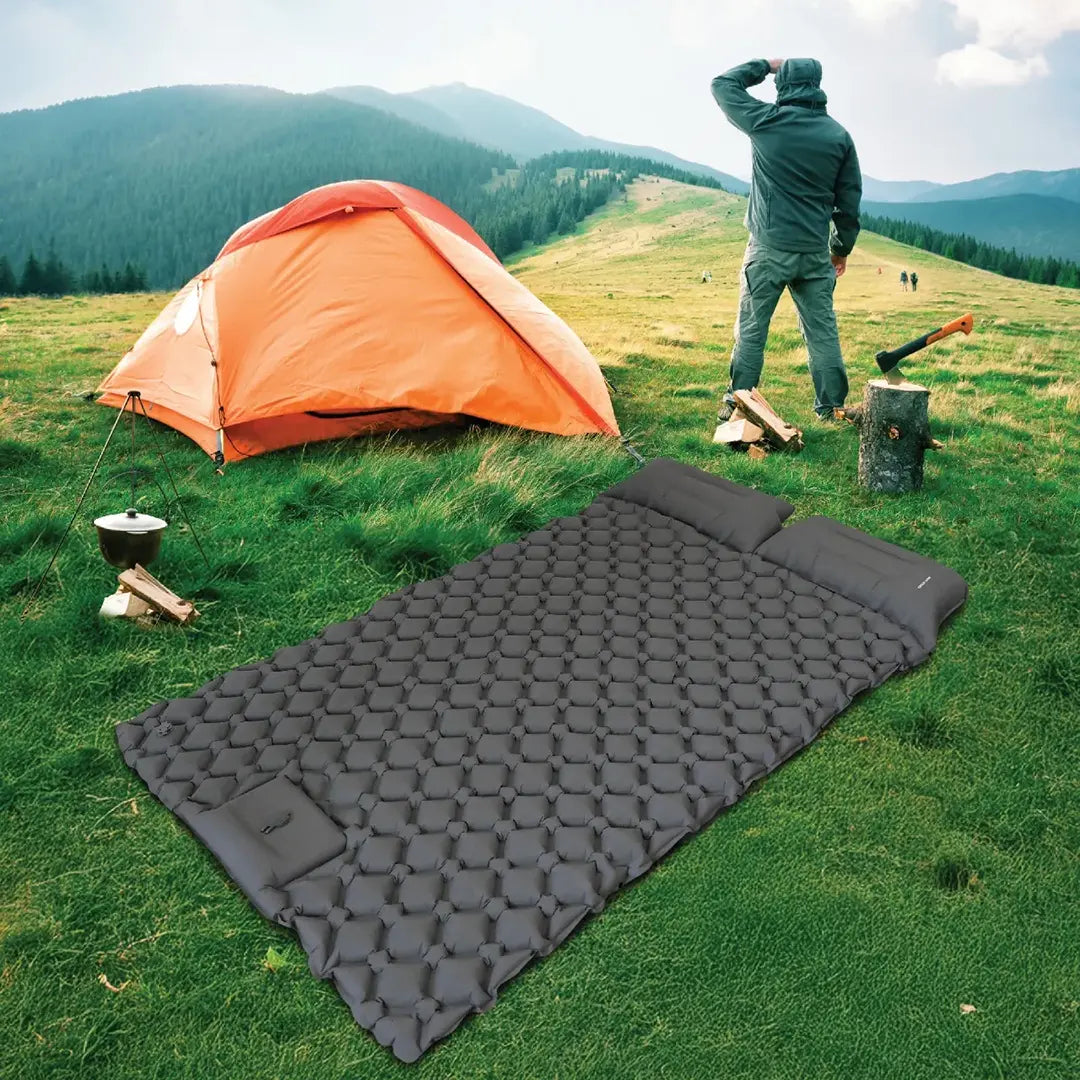 A Person is Using Green Lion Double Air Bed Inflatable Mattress While Camping.