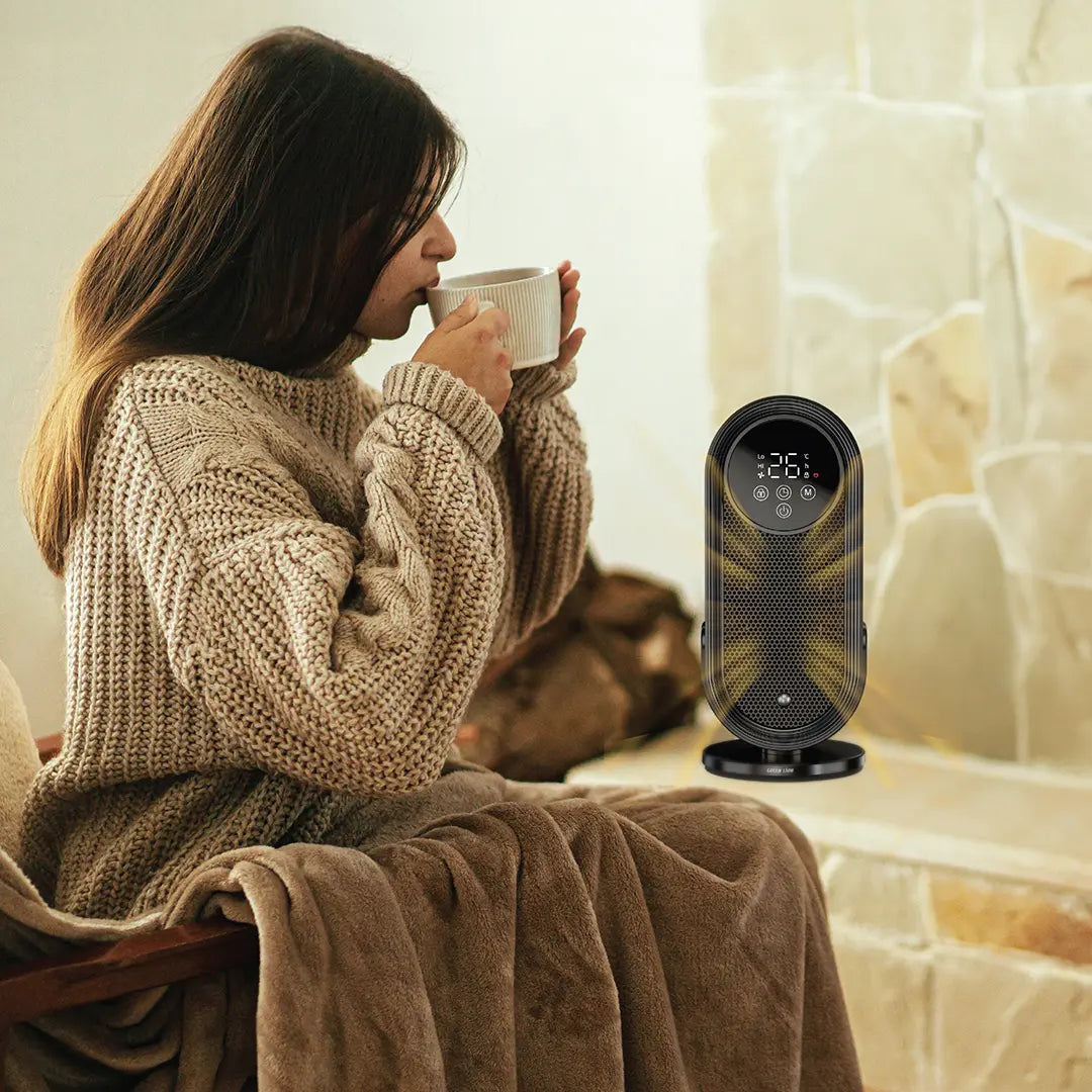 A Green Lion Heater Lite & Ceramic Fan Heater is Placeded in a Table and a Lady is Sitting Beside and having Coffee.