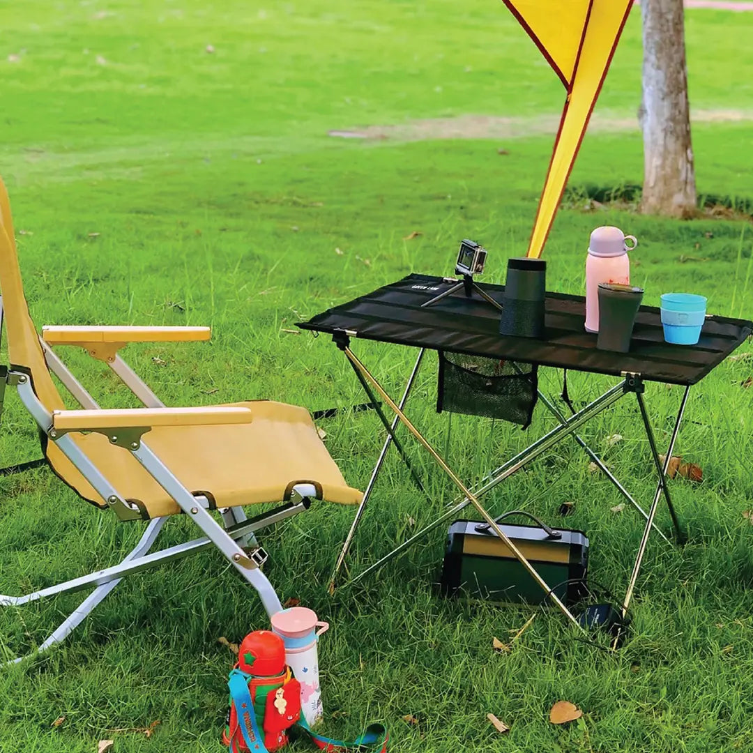 A Green Lion Outdoor Foldable Camping Table is Arranged Near Camping Area..