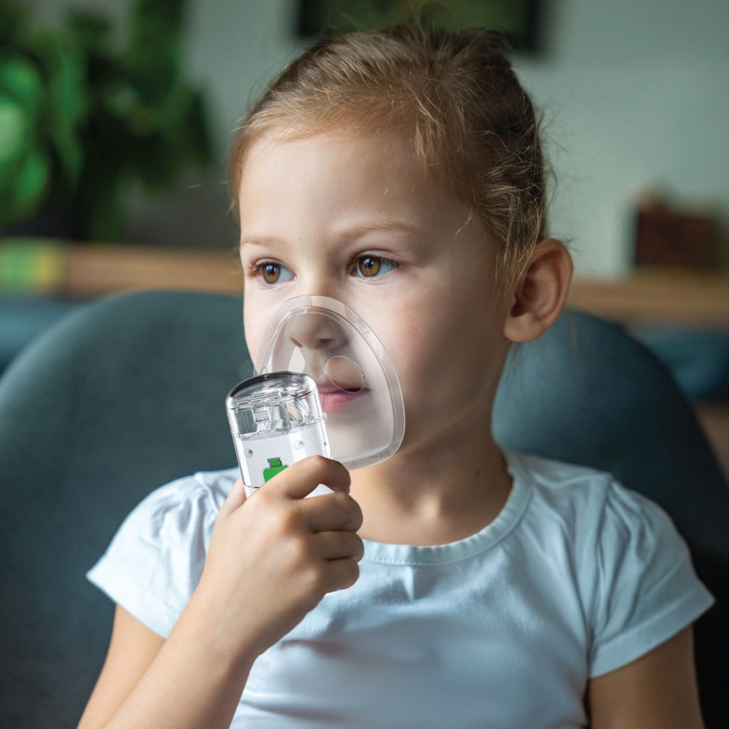 A Child is Using Green Lion Portable Nebulizer.