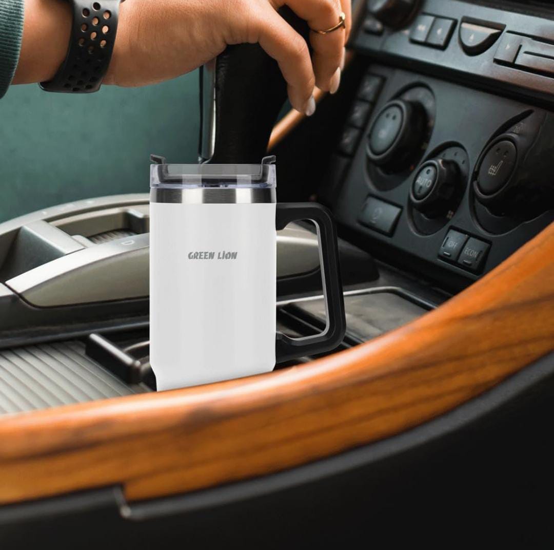 A Green Lion Vacuum Travel Mug is Placed in a Car.