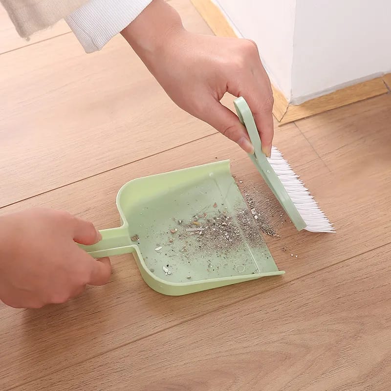 A Person is Cleaning Floor Using Mini Dustpan Broom Set.
