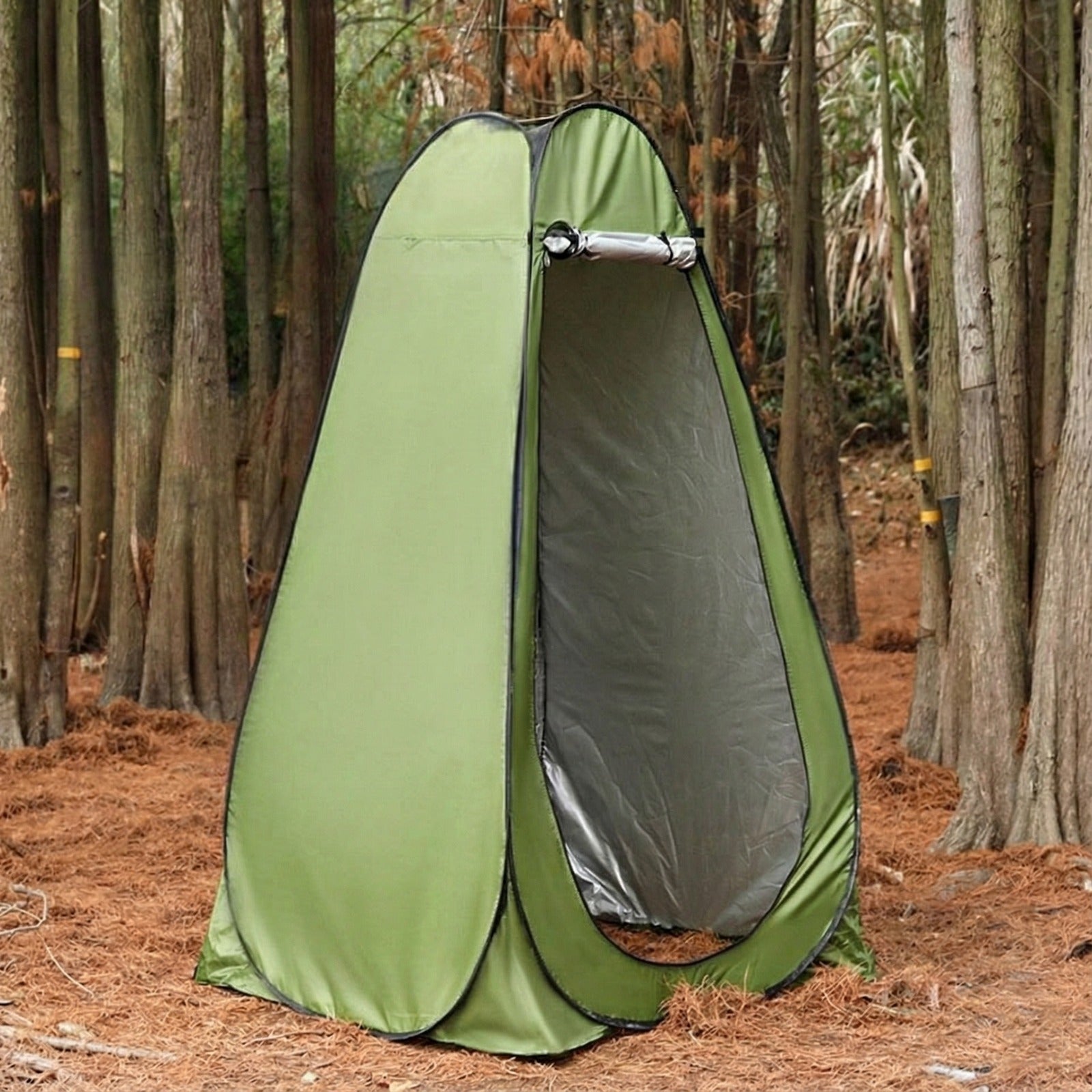 Green pop-up privacy tent for outdoor camping, designed for changing clothes, showering, or toilet use in the forest.
