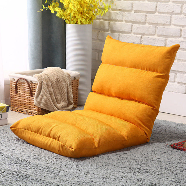 Orange color Lazy Lounge Sofa Bed placed near to a basket with cloths