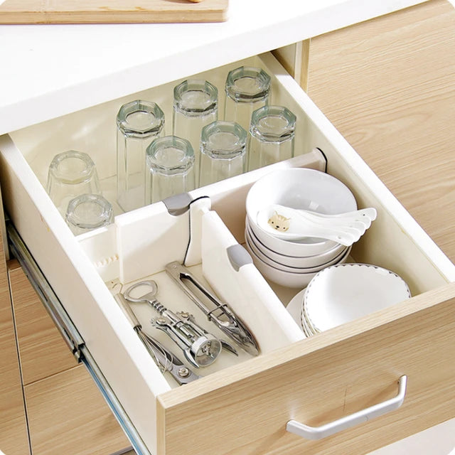 A drawer full of dishes and glasses separated with the help of drawer separator