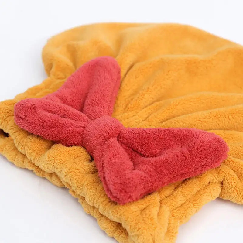 Yellow Hair Drying Cap with a red bow on a white background