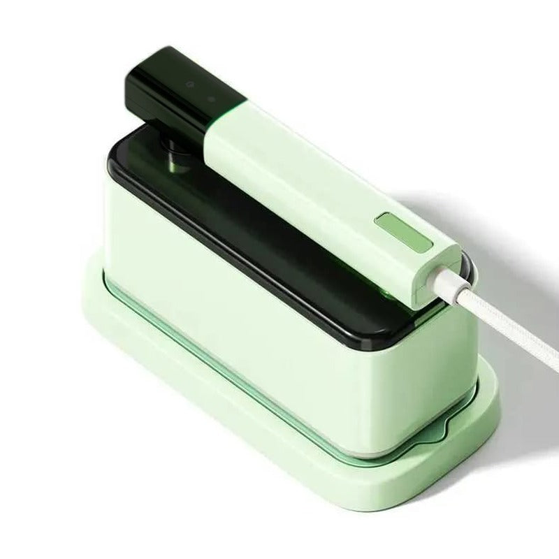 A Green Handheld Travel Garment Iron Steamer.