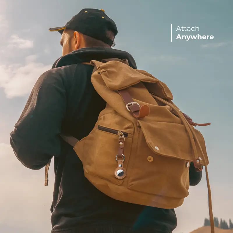 A Person Hanged Bluepebble Classic Leather Protective AirTag Case With Key Ring in His Bag.