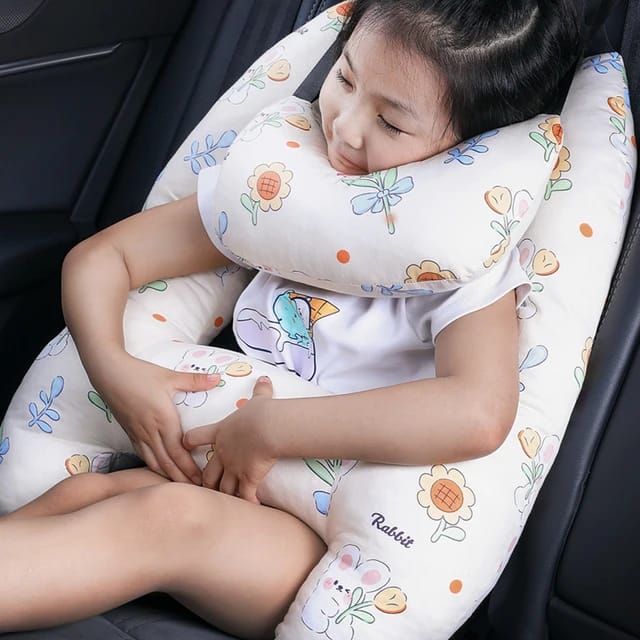 A child sitting in a car with the assistance of a Car Seat Travel Pillow
