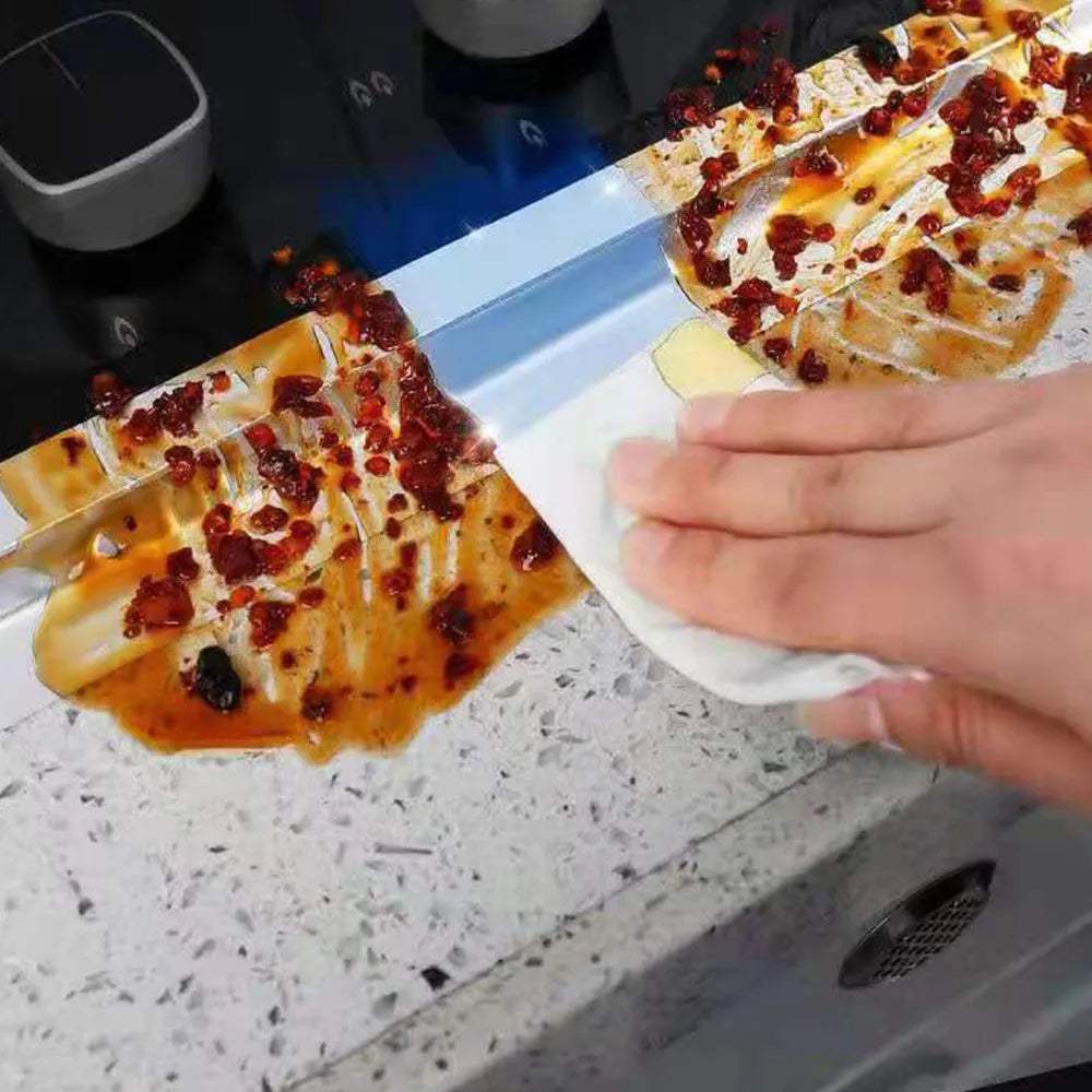 A person easily wiping off chilly sauce from a Leakproof Aluminum Foil Tape sticked on a counter top