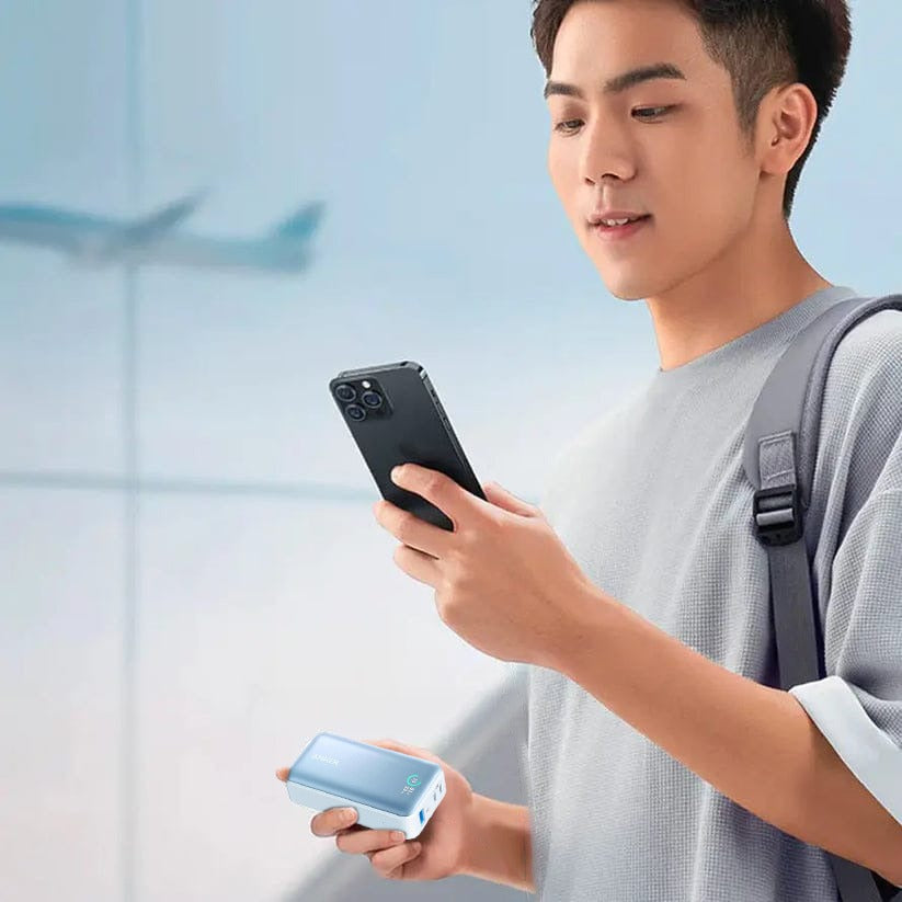 A Person is Holding Both Mobile Phone and Anker Ultra-Compact Power Bank (10,000mAh, 30W) -A1256H31.