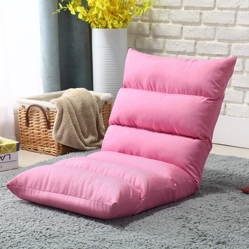 Pink color Lazy Lounge Sofa Bed placed near to a basket with cloths