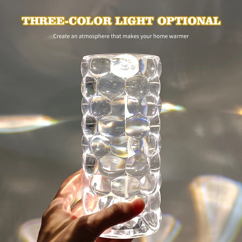Someone is holding the Water Drop Ambient Light Bedside 16 Colors LED Crystal Table Lamp
