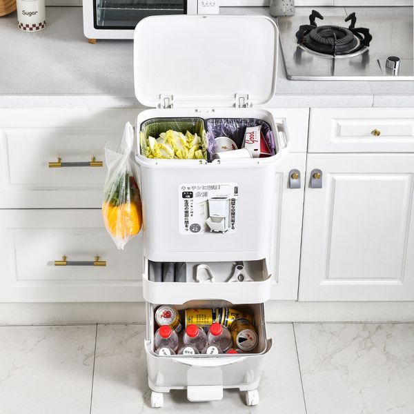 The kitchen features a garbage trash cans