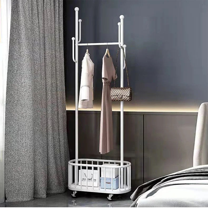 A Classic Minimalist Modern Metal Clothing Stand Wardrobe Garment Storage Rack with wheels is placed on the floor, adorned with dresses and bags