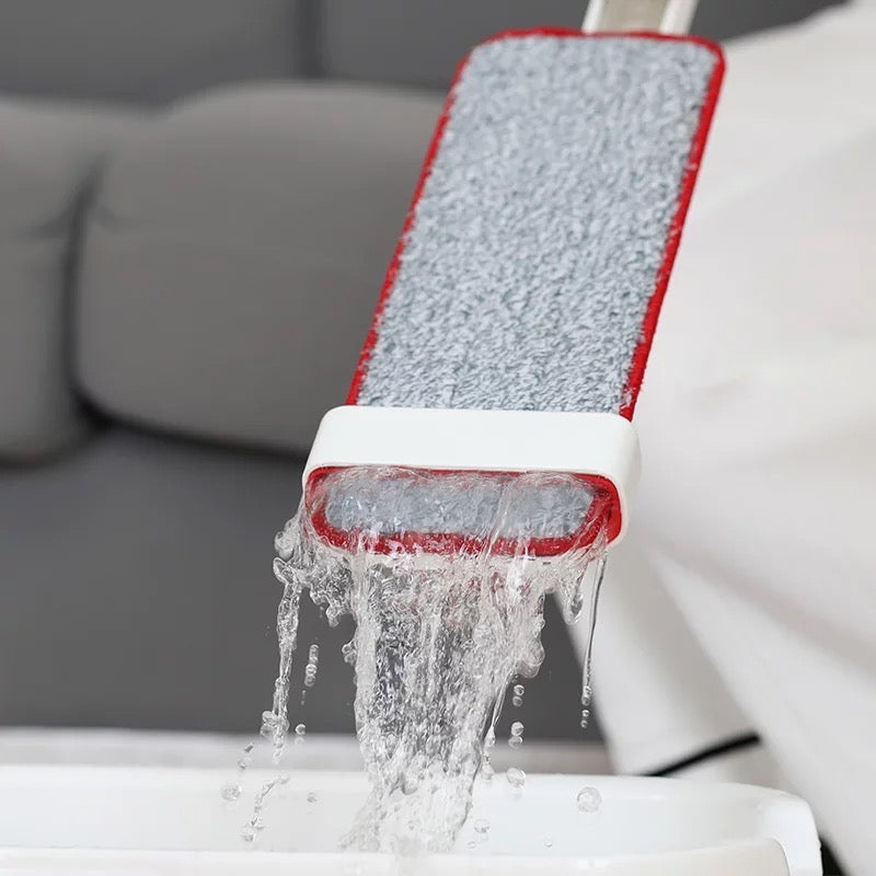 Lightweight Water Spray Mop being poured from a bucket