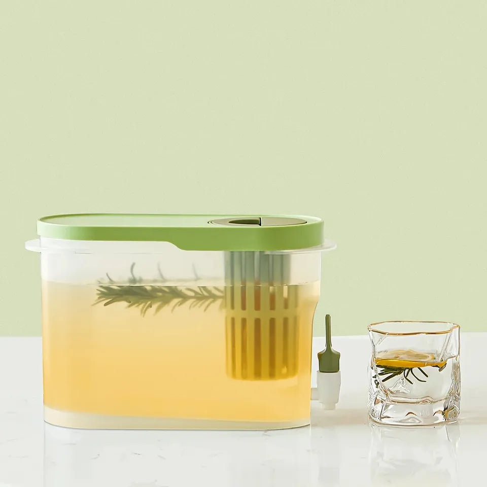 A Cold Kettle Beverage Dispenser with a green lid and a glass of liquid next to it