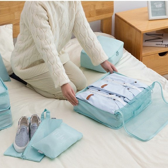 Woman neatly arranging clothes in a suitcase, utilizing Travel Packing Organizer Bags for efficient packing