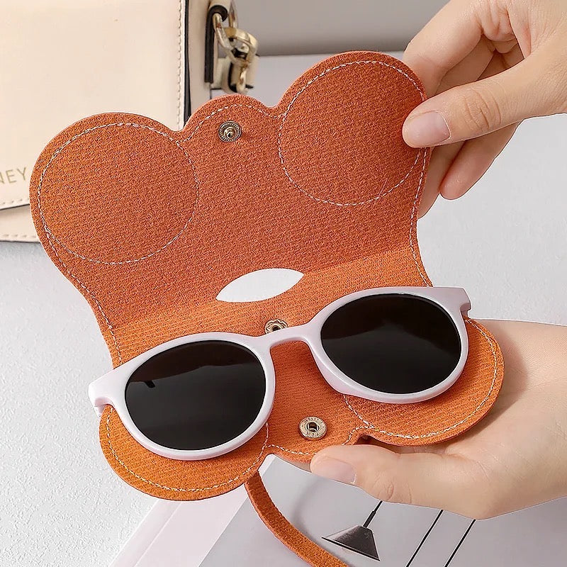 A unisex portable glasses bag, featuring a person holding an orange case containing sunglasses