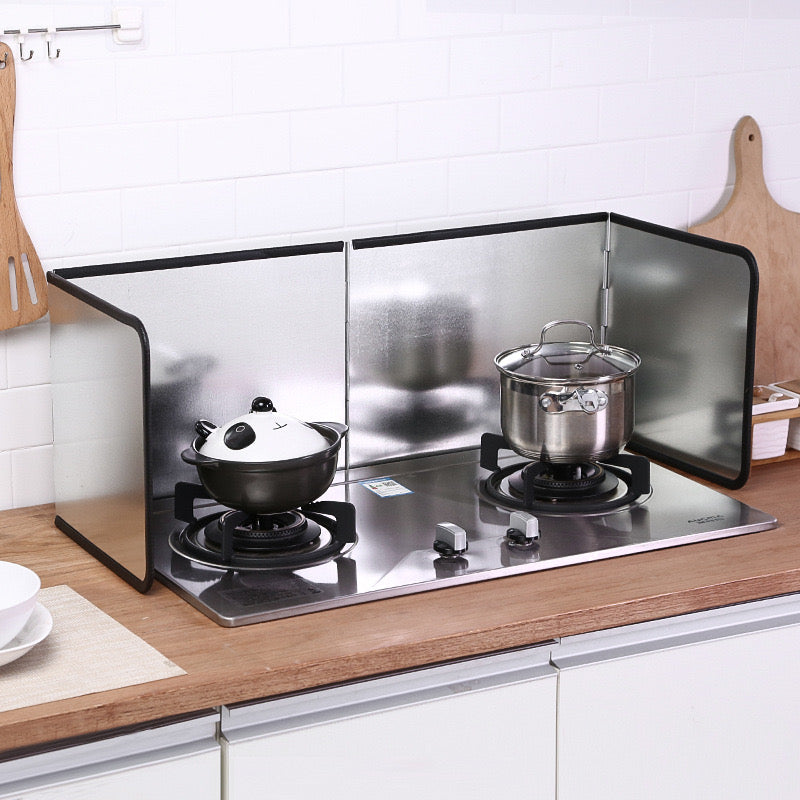 a stove with a couple pots on top and Gas Stove Oil-blocking Board