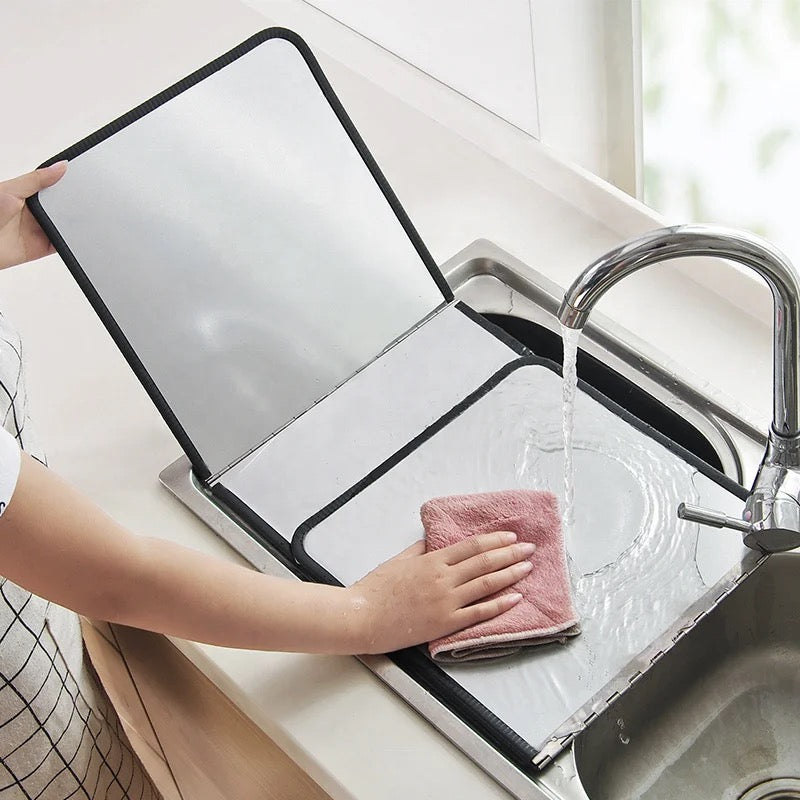 a person washing Gas Stove Oil-blocking Board in a sink