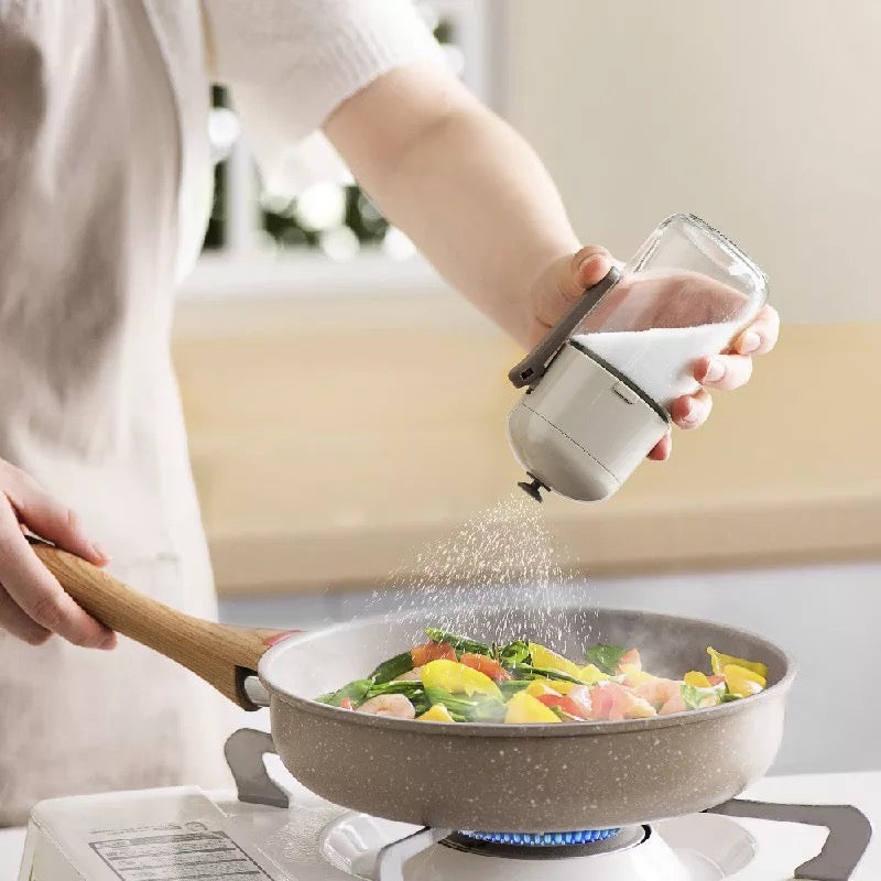 Someone putting salt from a 220ml Controlled Moisture-Proof Seasoning Bottle into food