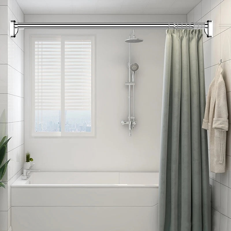 Extendable Tension Rod with curtain mounted in a bathroom beside to bathtub