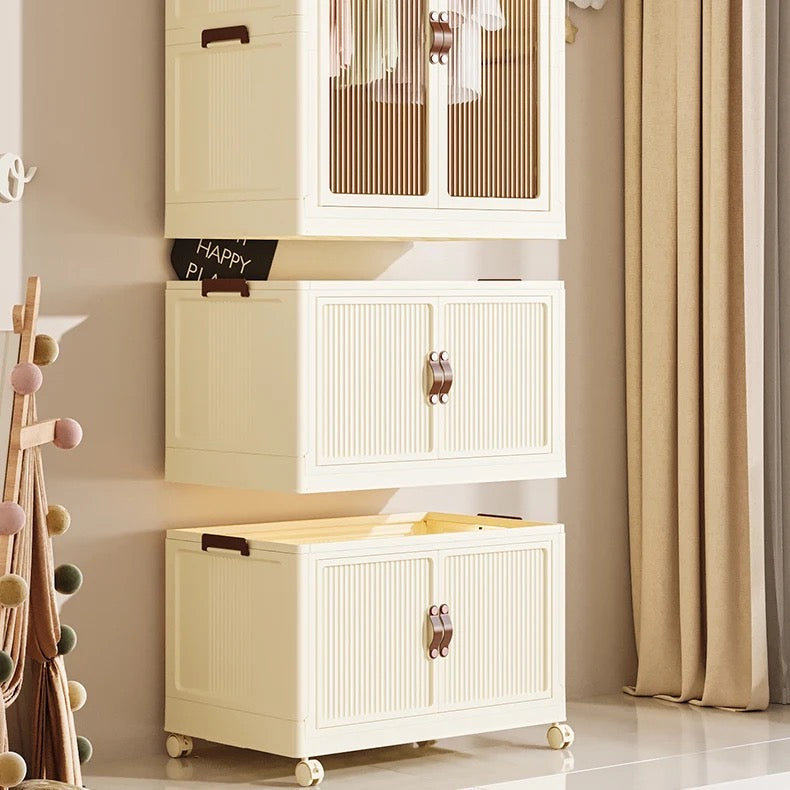 Portable folding storage cabinet with wheels placed on the floor in front of the wall