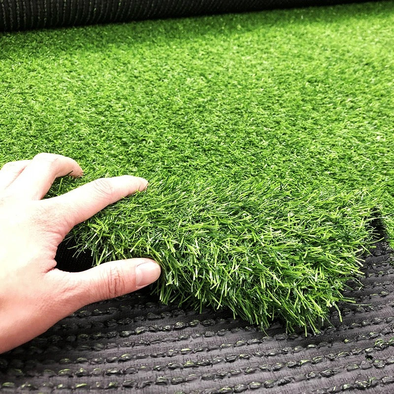 A person touching Artificial Grass Carpet