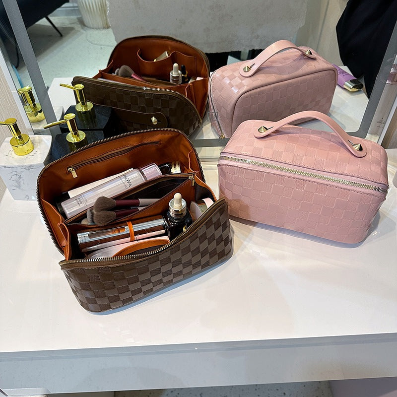Two Cosmetic Bags placed on a table,one stored of cosmetic items and left it open