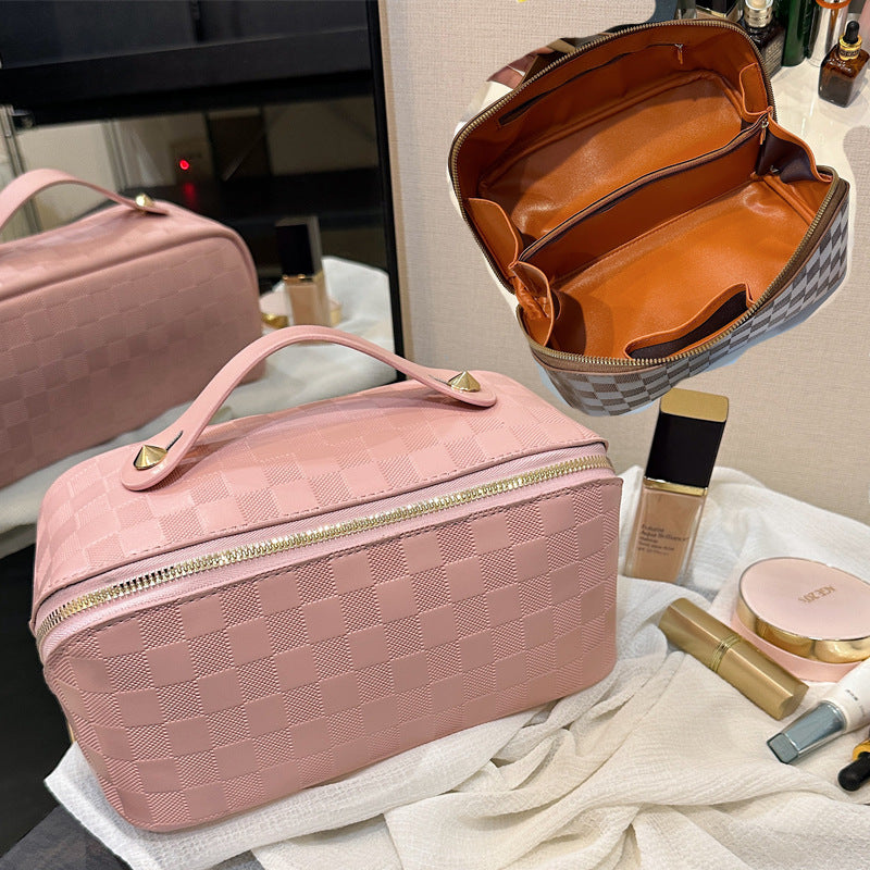 Pink color Cosmetic Bag kept next to cosmetic items on a table