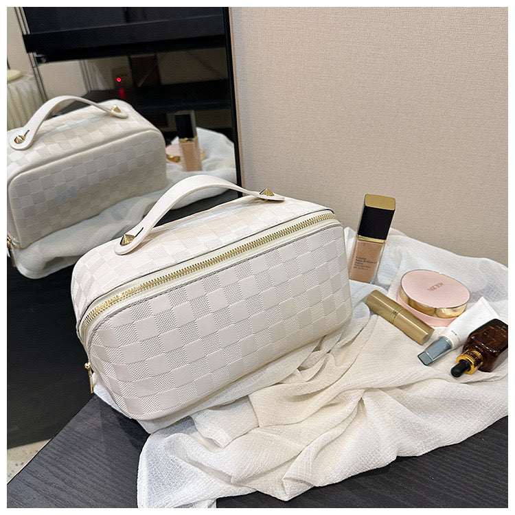 White color Cosmetic Bag kept next to cosmetic items on a table