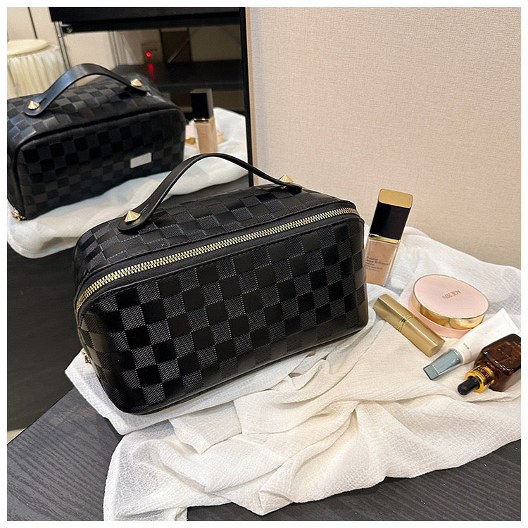 Black color Cosmetic Bag kept next to cosmetic items on a table