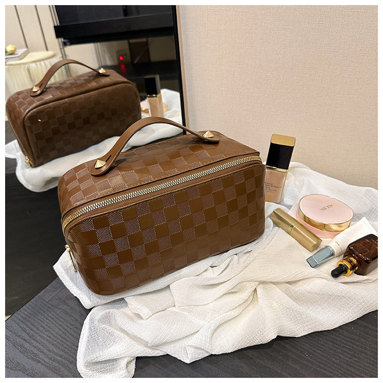 Brown color Cosmetic Bag kept next to cosmetic items on a table