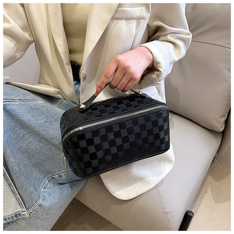 A lady holding Black color Cosmetic Bag