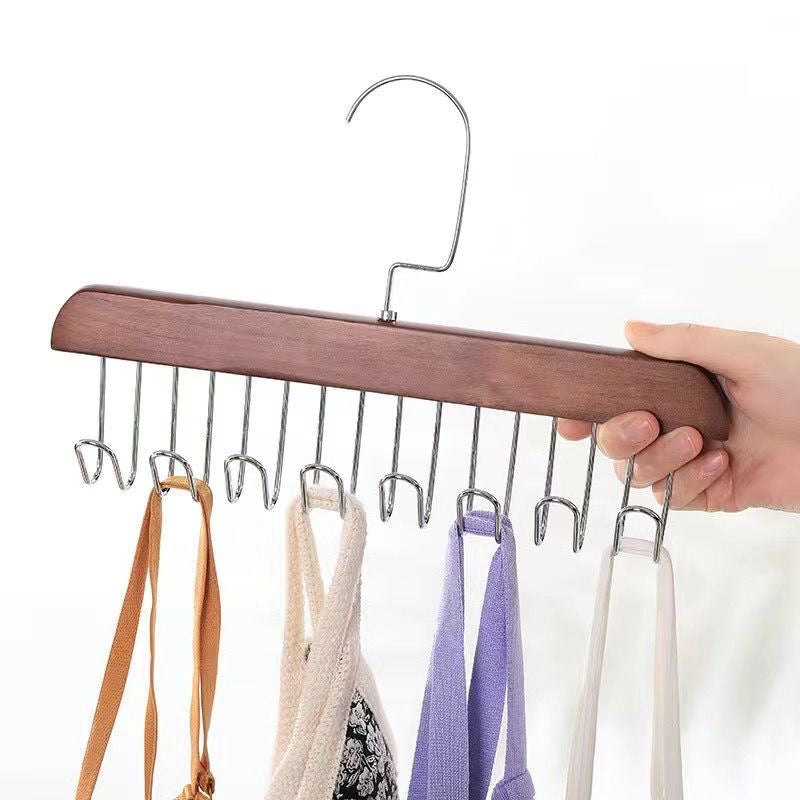 A person securely holds an 8 Hooks Non-Slip Hanger, displaying multiple clothes hanging neatly on a Hanger