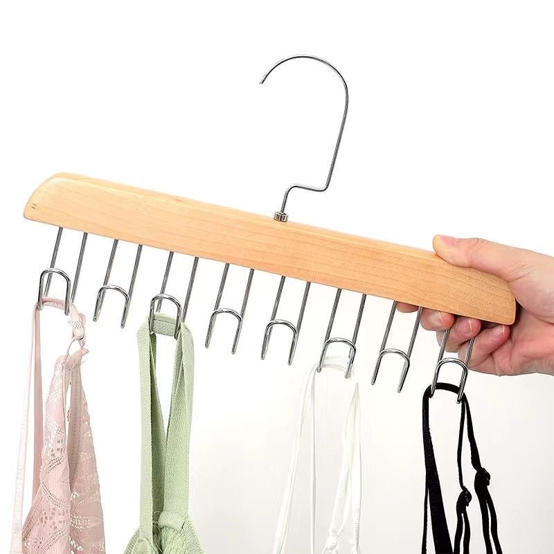 A person securely holds an 8 Hooks Non-Slip Hanger, displaying multiple clothes hanging neatly on a Hanger