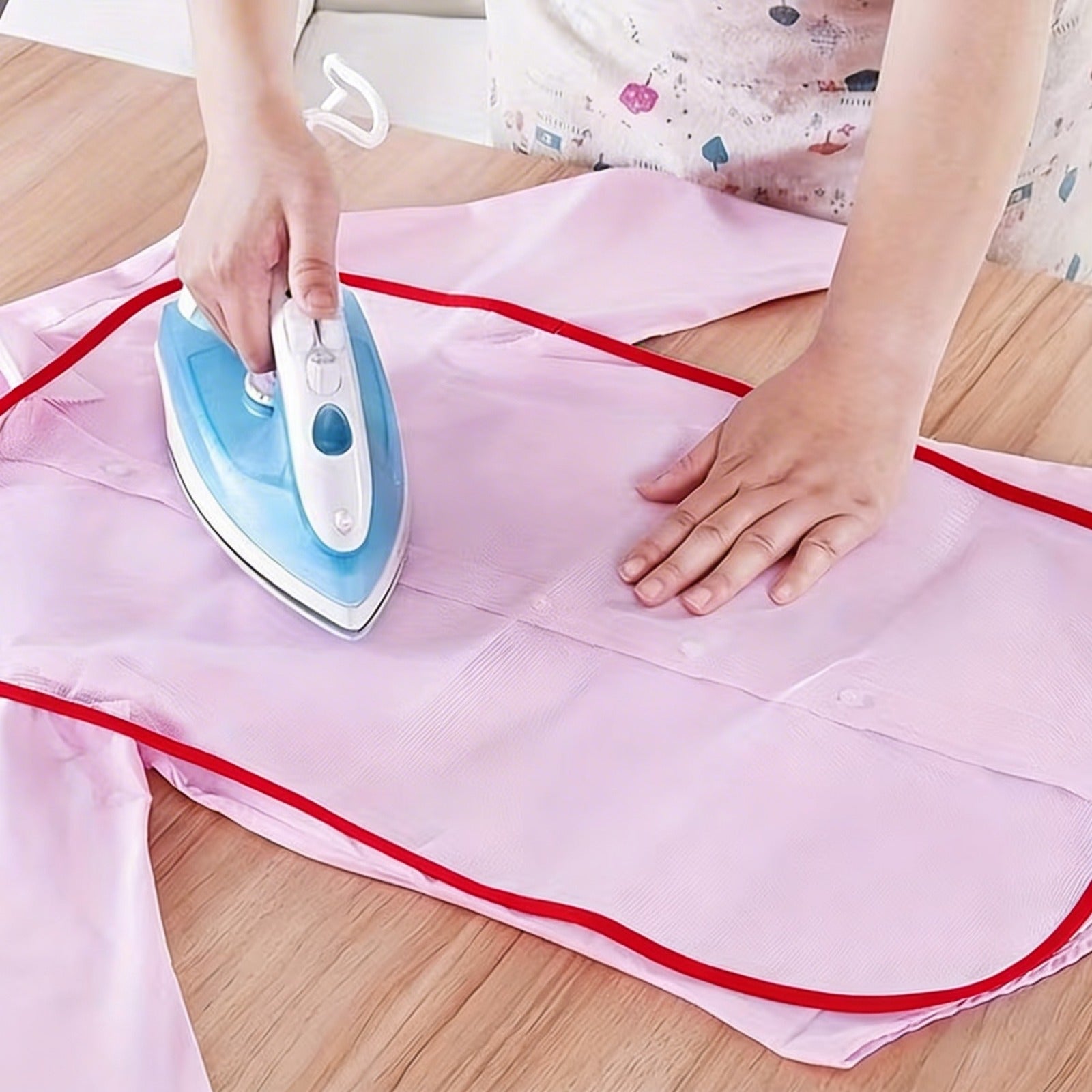 A person using a steam iron over a garment covered with a mesh protective cloth pad, designed to prevent direct heat contact, avoid burns or shine marks, and protect delicate fabrics during ironing.