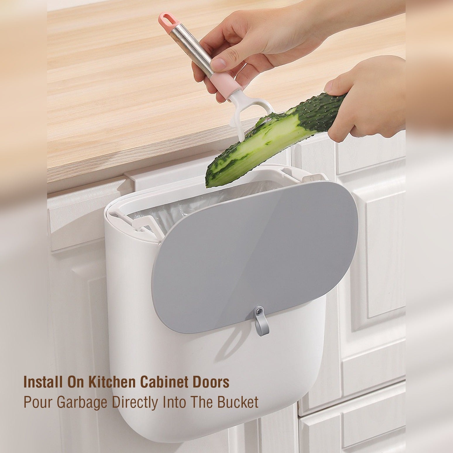 A Person is Peeling Cucmber in to Kitchen Garbage Bin.