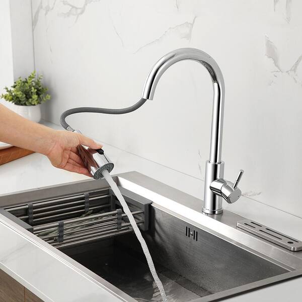 A Person is Cleaning Sink Using Kitchen Pull Out Tap.