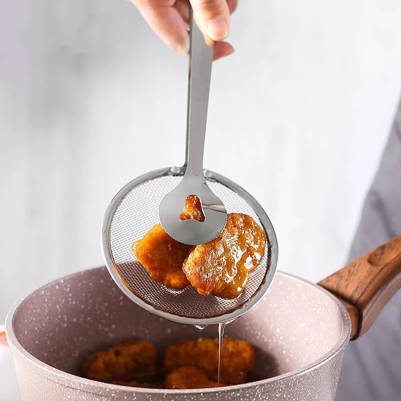 A Person is Frying Snacks Using Stainless Steel Strainer.